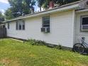 Side view of a small house with a bicycle and lawn at 2220 S Burke St, Indianapolis, IN 46231