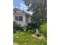Side view of a small house with a fountain and yard art at 2220 S Burke St, Indianapolis, IN 46231