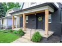 Inviting front porch features stylish wood posts and a black brick exterior at 1134 St Peter St, Indianapolis, IN 46203