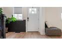 Bright entryway with modern flooring, a white door, and dark wainscoting at 1134 St Peter St, Indianapolis, IN 46203