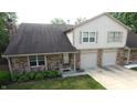 Two-story home with double garage and landscaped yard at 7433 Prairie Lake Dr, Indianapolis, IN 46256