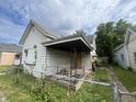 White sided house with covered porch needs repairs at 2327 Hoyt Ave, Indianapolis, IN 46203