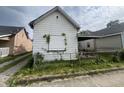A small white house needing renovation, in need of repairs at 2327 Hoyt Ave, Indianapolis, IN 46203