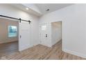 Bright entryway with barn door and hardwood floors at 706 S Main St, Whitestown, IN 46075