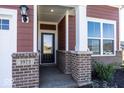 Front entryway with a dark door and brick columns at 3973 Willow Branch Way, Westfield, IN 46062