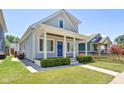 Two-story gray house with a blue door and a walkway to the porch at 805 Iowa St, Indianapolis, IN 46203