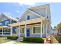 Gray house with a blue door, white columns, and a landscaped front yard at 805 Iowa St, Indianapolis, IN 46203