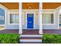 Inviting front porch with a blue door and a wood-grain floor at 805 Iowa St, Indianapolis, IN 46203
