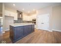 Modern kitchen with island and stainless steel appliances at 7942 Beaumont Green Pl, Indianapolis, IN 46250