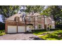 Brick home with white accents, large driveway at 6463 N Illinois N St, Indianapolis, IN 46260
