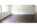 Spacious living room featuring dark hardwood floors and large windows at 3720 Breen Dr, Indianapolis, IN 46235