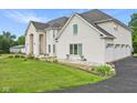 White brick house with three-car garage and manicured lawn at 8292 S State Road 39 S Rd, Clayton, IN 46118