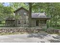 Log cabin home with stone wall and landscaping at 2705 S 975 E, Zionsville, IN 46077