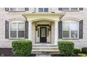 Elegant home entrance with columns and dark door at 8235 Ridge Valley Ct, Indianapolis, IN 46278