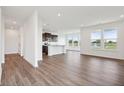 Spacious living room with hardwood floors and kitchen views at 225 Marble Wood Dr, Danville, IN 46122