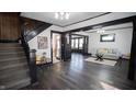 Living room with dark hardwood floors and a view of the kitchen at 526 N Emerson Ave, Indianapolis, IN 46219
