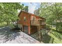 Wooden house with a deck, garage, and driveway at 8157 Center Lake Rd, Nineveh, IN 46164