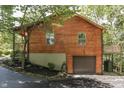 Wooden house with a deck, garage, and driveway at 8157 Center Lake Rd, Nineveh, IN 46164