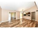 Open living room with vaulted ceiling, laminate floors, and kitchen access at 2719 E 28Th St, Indianapolis, IN 46218