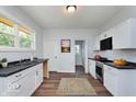 Modern kitchen with white cabinets and dark countertops at 906 N Parker Ave, Indianapolis, IN 46201