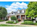 Brick house with a two-car garage and landscaped yard at 15482 Bridgewater Club Blvd, Carmel, IN 46033