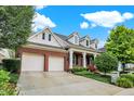 Brick house with a two-car garage and landscaped yard at 15482 Bridgewater Club Blvd, Carmel, IN 46033