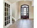 Elegant entryway with a tiled floor, arched doorways, and a wooden door at 2929 Post Oak Ct, Westfield, IN 46074
