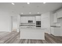 Modern kitchen featuring white cabinets, quartz countertops, and stainless steel appliances at 16910 Cattle Hollow Ln, Noblesville, IN 46060