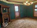 Dark green dining room with wood fireplace at 202 N State St, Greenfield, IN 46140