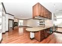 Kitchen with granite counter, wood cabinets, and hardwood floors at 350 N Meridian St # A301, Indianapolis, IN 46204