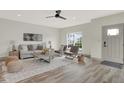 Bright living room features a comfy sofa, stylish coffee table, and large windows at 220 Sanders St, Indianapolis, IN 46225