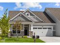 Gray and beige two-story home with a two-car garage and landscaped yard at 10626 Maidenhair Dr, Indianapolis, IN 46239