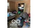 Cluttered living room, showing a view into the kitchen at 3321 S Rybolt Ave, Indianapolis, IN 46221