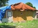 House exterior covered in tarp, showing damage at 3321 S Rybolt Ave, Indianapolis, IN 46221