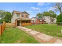 Front view of a charming house with a stone walkway and a wooden fence at 4513 Norwaldo Ave, Indianapolis, IN 46205