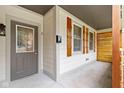 Front porch with a gray door and wood accent wall at 4513 Norwaldo Ave, Indianapolis, IN 46205