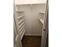 Empty pantry with white shelves and wood floor at 14 Winchester Ct, Anderson, IN 46013