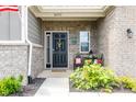 Brick front porch with seating area at 16311 Taconite Dr, Noblesville, IN 46060