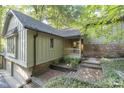 Brick and wood exterior home with landscaping and a walkway at 6235 Johnson Rd, Indianapolis, IN 46220