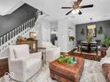 Living room with hardwood floors, fireplace, and adjacent dining area at 11320 Fonthill Dr, Indianapolis, IN 46236