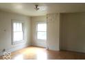 Bright bedroom with hardwood floors and two windows at 3358 Ruckle St, Indianapolis, IN 46205