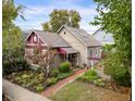 Tan house with maroon accents and a landscaped front yard at 646 E 9Th St, Indianapolis, IN 46202