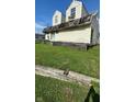 Two-story house, light beige siding, gabled roof and small yard at 3302 Columbus Ave, Anderson, IN 46013