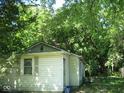 Exterior of a small white house surrounded by trees at 2625 S Rybolt Ave, Indianapolis, IN 46241