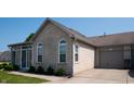 Brick home with sunroom and attached garage at 5839 Quail Run Dr, Indianapolis, IN 46237
