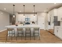 Modern kitchen with white cabinets, island, and stainless steel appliances at 7123 Bailow Ct, McCordsville, IN 46055