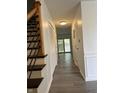 Bright hallway with wood-look flooring and multiple doors at 1159 Canterbury S Sq, Indianapolis, IN 46260