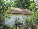 Older home with damaged roof and white siding at 3242 S Rybolt Ave, Indianapolis, IN 46221