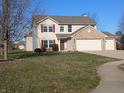 Two-story house with brick and siding, two-car garage, and landscaped yard at 992 Paige Ct, Greenfield, IN 46140