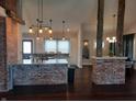 Open kitchen with exposed brick breakfast bar and island at 1344 Barth Ave, Indianapolis, IN 46203